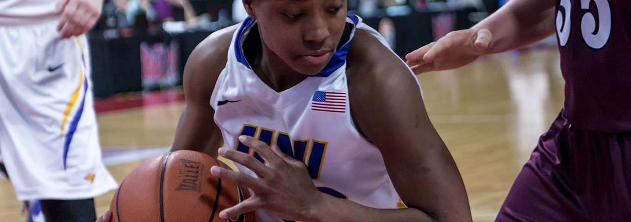 UNI Women's basketball player with ball in tournament