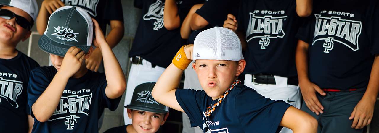 Youth boys baseball team goofing around in dugout.