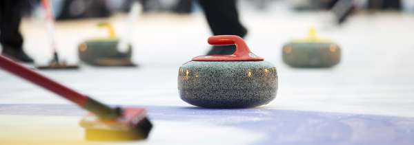 Curling competition with focus on curling rock