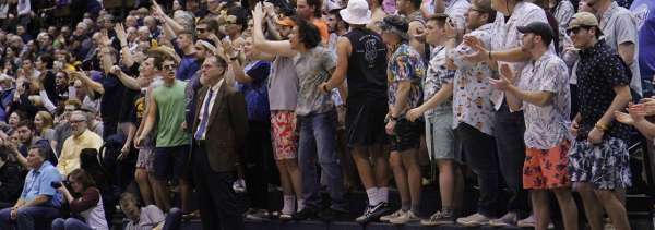 Fans in bleachers cheering on their team
